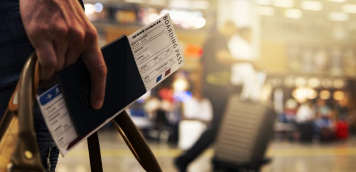 manos-de-persona-sosteniendo-tiquetes-de-avion